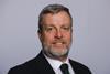 The image shows a headshot of Finlay Carson MSP in a black suit and tie