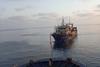 Fishing vessel being towed at sea