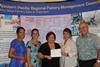 Kitty Simonds, Council executive director (centre), presents Claire Poumele, Council member and American Samoa Port Administration director, with a cheque to support development of a longline vessel dock in Pago Pago Harbour