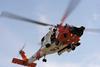 A Coast Guard MH-60 Jayhawk rescue helicopter safely hoisted both men from the life raft