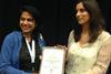 Marta Gameiro, Global Technical Services Manager for NAH Aqua, congratulates Kiranpreet Kaur on receiving the Young Scientist Award