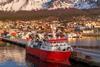 Fishing vessel with mountains behind
