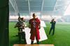 Erling Haaland with his back to the camera at a football stadium being filmed for an ad campaign by the Norwegian Seafood Council