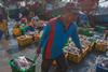 The image shows an Indonesian fisher on board a vessel