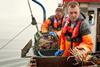 Brian Chambers on board a fishing vessel landing a large crab