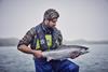Loch_Duart_husbandryman_holding_salmon