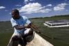 A Haitian man paddles out to his fish farm. Brazil and FAO are partnering to spread aquaculture in the Caribbean and elsewhere © FAO/Luca Tommasini