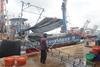 The image shows a Thai fishing vessel on the quayside