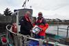 Dougie Brown, right, receiving his new free PFD from Iain MacEachan of Marine Scotland onboard his replacement boat