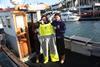 Jamie Fitzgerald with the trousers that saved his life, standing beside his father, Noel. After the accident, Jamie got his father a jacket and pair of the trousers with the built-in buoyancy.