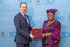 The image shows Mr. Burim Bilali, Acting Permanent Representative, presenting North Macedonia’s instrument of acceptance to WTO, director-general Ngozi Okonjo-Iweala.