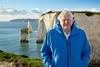 Image of Sir David Attenborough standing by the coast to promote his 'Ocean' film