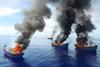 Four Vietnamese Blue Boat vessels burn on June 12 after Palau authorities caught them fishing illegally. © Jeff Barabe for The Pew Charitable Trusts