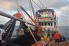 Workers onboard a Thai fishing vessel