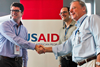 USAID Maximizing Agricultural Revenue through Knowledge, Enterprise Development and Trade project’s Chief of Party Tim Moore (left) congratulates Gerald Knecht, CEO of P.T. Bali Seafood (right) and David Solomon, CEO of Pelagic Data Systems. Credit: USAID