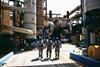 Three workers outside at a fish oil and fishmeal factory