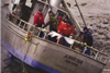 Nesika, beached after capsising, with Coast Guard personnel onboard