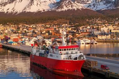 Fishing vessel with mountains behind
