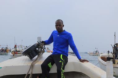 Member of Project Recon sat on board a boat with a recovered echosounder buoy