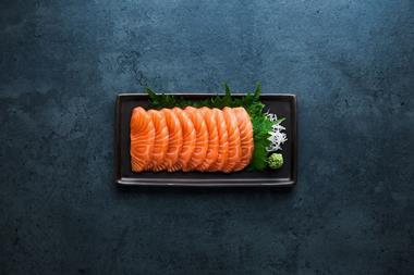 Sashimi laid on a black oblong plate