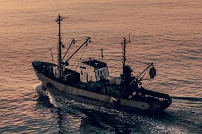 EU fishing boat at sunset