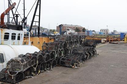 Pots stacked at  the harbour in Milford Haven, Wales