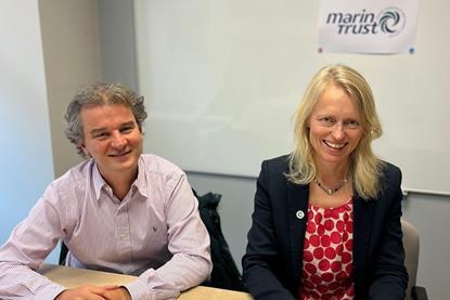 Nicolas Guichoux, chief programme officer at MSC, and Libby Woodhatch, executive chair at MarinTrust sitting at a desk during an MoU signing