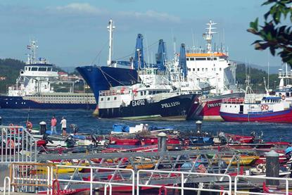 The image shows Spanish fishing vessels in port