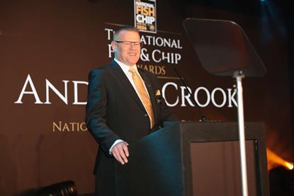 Andrew Crook, president of the National Federation of Fish Friers standing at a podium at the National Fish & Chip Awards 2024