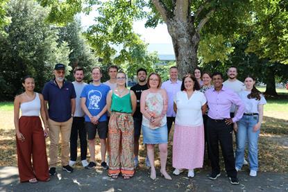 Members of Aviwell standing outside by trees