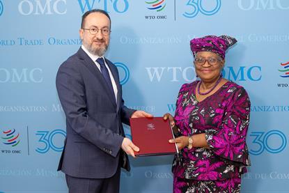 The image shows Mr. Burim Bilali, Acting Permanent Representative, presenting North Macedonia’s instrument of acceptance to WTO, director-general Ngozi Okonjo-Iweala.