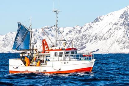 The image shows a Norwegian fishing vessel on the water with the snowy coastline in the background