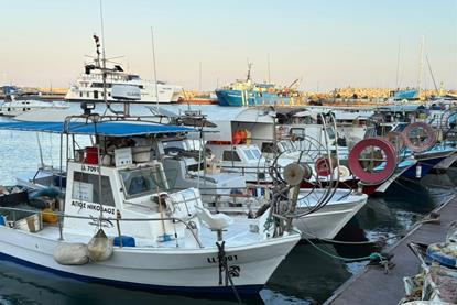 Small fishing boats lined up at a pontoon