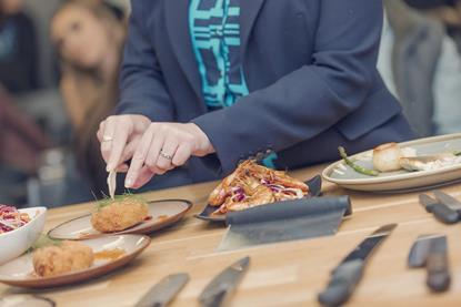 Someone cutting into seafood at the UK Seafood School in Grimsby