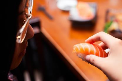 A picture of Norwegian salmon being consumed as sushi