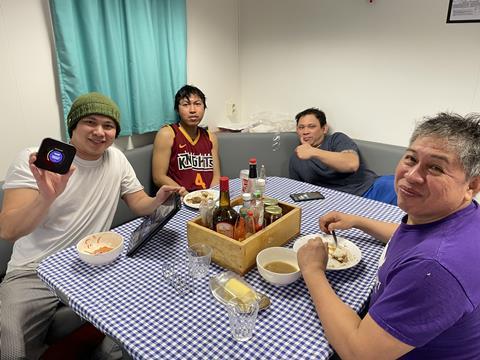 Fishers on board accessing the internet whilst enjoying a meal