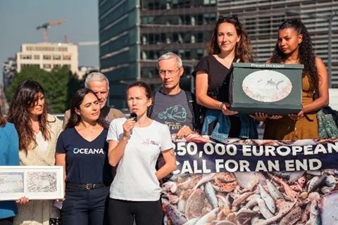 The image shows Oceana representatives taking the petition to the EU