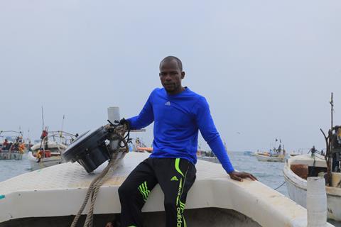 Member of Project Recon sat on board a boat with a recovered echosounder buoy