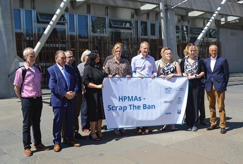Members of fishing organisations holding a 'HPMA - Scrap The Ban' poster
