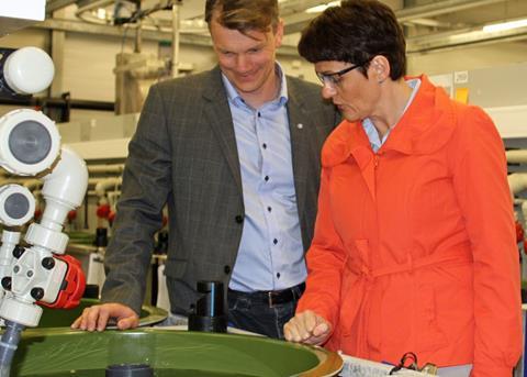 Lisbeth Berg-Hansen and the manager of cod farming company Skei Marinfisk AS, Knut Elling Bråthen, look at a fry tank during a tour of the National Cod Breeding Centre in Tromsø. Credit: Wilhelm Solheim © Nofima