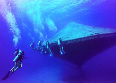 Divers around the open-ocean aquaculture cage at the Cape Eleuthera Institute. Credit: Kelly Martin