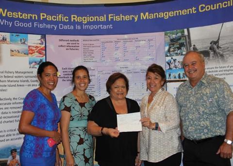Kitty Simonds, Council executive director (centre), presents Claire Poumele, Council member and American Samoa Port Administration director, with a cheque to support development of a longline vessel dock in Pago Pago Harbour