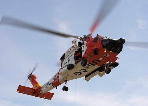 A Coast Guard MH-60 Jayhawk rescue helicopter safely hoisted both men from the life raft