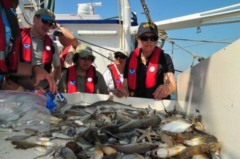 NOAA officials assess how samples are processed aboard the research vessel Caretta and the chain of custody protocols used when handling specimens associated with the oil spill. (Photo: NOAA)