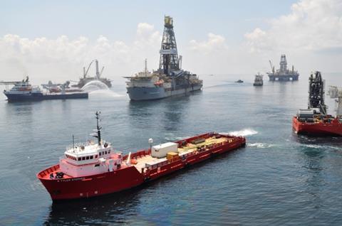 Ships and drilling rigs surround the Discoverer Enterprise as it continues to recover oil from the Deepwater Horizon drill site June 15, 2010. (Photo: US Coast Guard)