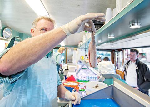 Fishtrader Peter with a matjes herring ready for consumption. Credit: Jon-Are Berg-Jacobsen © Nofima