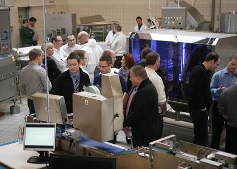 Executives from the international salmon processing industry examine Marel salmon processing equipment at last year’s Salmon ShowHow