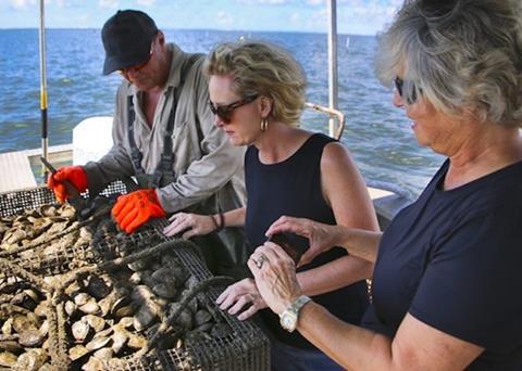 Louisiana USDA rural development director, Carrie Castille (centre) and Deborah Atwood of the Meridian Institute visit the oyster farm of Jules Melancon on Grand Isle Photo: Ed Lallo/Lallo Photography