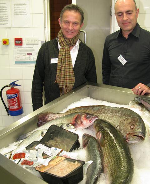Miguel (r) and Lacky with two enormous five-year-old Meagre Stone Bass, white-leg shrimp, sea bass, prawns and sliced red chorizo fish sausage snacks. Credit: TW : EEC Photos