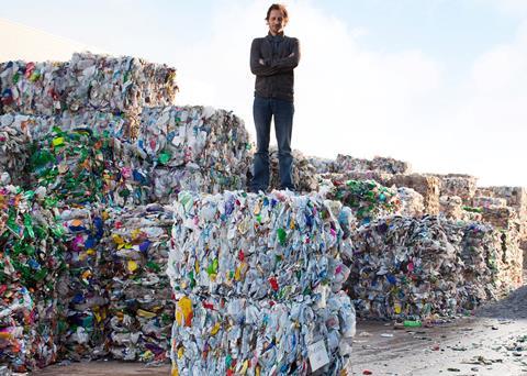 Tom Doman, Innovations Manager at Ecover on a bale of plastic waste